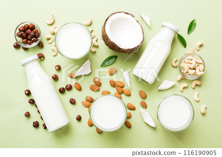 Set or collection of various vegan milk almond, cashew, on table background. Vegan plant based milk and ingredients, top view 116190905