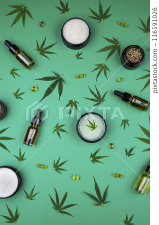Flat lay composition of marijuana and hemp seeds on green color paper background 116191026