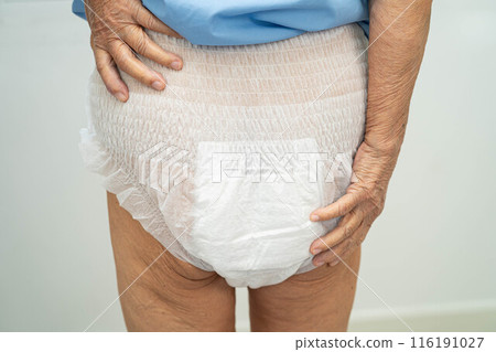 Asian elderly woman wearing diaper for loss of bladder urinary incontinence control. 116191027