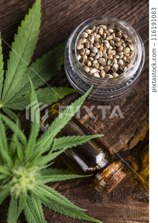Cbd hemp oil in bottle and marijuana leaves Cbd hemp oil in bottle and marijuana leaves 116191083