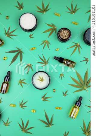 Composition with hemp oil cbd and bottle of oil on green background Composition with hemp oil cbd and bottle of oil on green background 116191102
