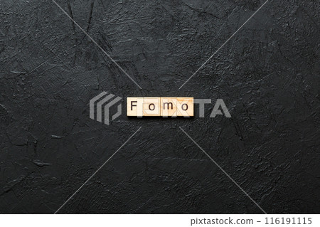 fomo word written on wood block. fomo text on table, concept fomo word written on wood block. fomo text on table, concept 116191115