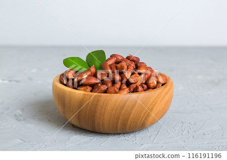 Fresh healthy peanuts in bowl on colored table background. Top view Healthy eating bertholletia concept. Super foods Fresh healthy peanuts in bowl on colored table background. Top view Healthy eating bertholletia concept. Super foods 116191196