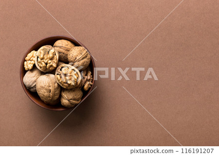 Fresh healthy walnuts in bowl on colored table background. Top view Healthy eating bertholletia concept. Super foods Fresh healthy walnuts in bowl on colored table background. Top view Healthy eating bertholletia concept. Super foods 116191207