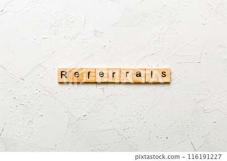 REFERRALS word written on wood block. REFERRALS text on cement table for your desing, concept REFERRALS word written on wood block. REFERRALS text on cement table for your desing, concept 116191227