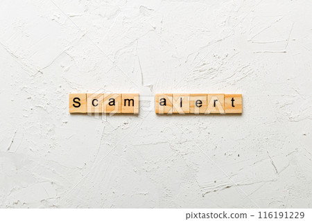 Scam alert word written on wood block. Scam alert text on table, concept 116191229