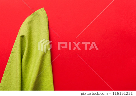 top view with green kitchen napkin isolated on table background. Folded cloth for mockup with copy space, Flat lay. Minimal style top view with green kitchen napkin isolated on table background. Folded cloth for mockup with copy space, Flat lay. Minimal style 116191231