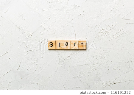 Start word written on wood block. Start text on cement table for your desing, concept Start word written on wood block. Start text on cement table for your desing, concept 116191232