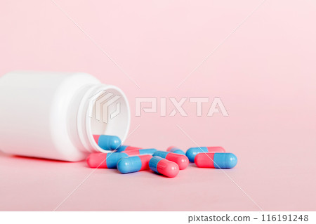 plastic medicine bottle with capsules of pills on colored background. Online pharmacy. Painkiller medicine and antibiotic drug resistance concept. Pharmaceutical industry plastic medicine bottle with capsules of pills on colored background. Online pharmacy. Painkiller medicine and antibiotic drug resistance concept. Pharmaceutical industry 116191248