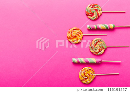Set of colorful lollipops on colored background. Summer concept. Party Happy Birthday or Minimalist Concept Set of colorful lollipops on colored background. Summer concept. Party Happy Birthday or Minimalist Concept 116191257