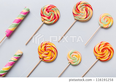Set of colorful lollipops on colored background. Summer concept. Party Happy Birthday or Minimalist Concept Set of colorful lollipops on colored background. Summer concept. Party Happy Birthday or Minimalist Concept 116191258