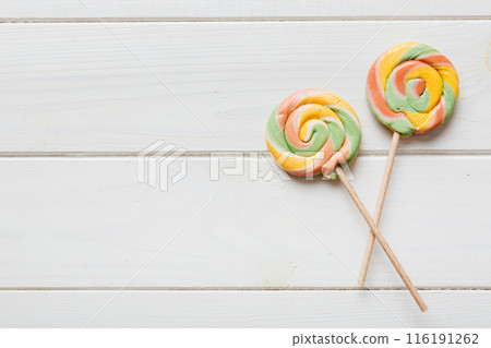 Set of colorful lollipops on colored background. Summer concept. Party Happy Birthday or Minimalist Concept Set of colorful lollipops on colored background. Summer concept. Party Happy Birthday or Minimalist Concept 116191262