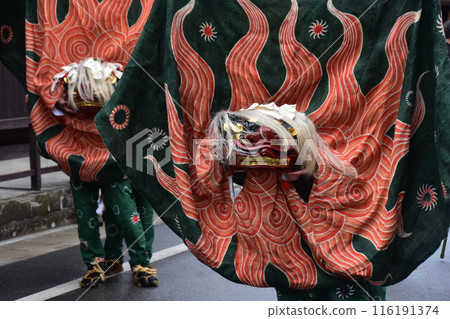 Takayama City, Gifu Prefecture, Japan: Traditional performing arts at the Takayama Spring Festival. Lion dancers parade through the streets in festival costumes, shaking the lion's face. Takayama City, Gifu Prefecture, Japan: Traditional performing arts at the Takayama Spring Festival. Lion dancers parade through the streets in festival costumes, shaking the lion's face. 116191374