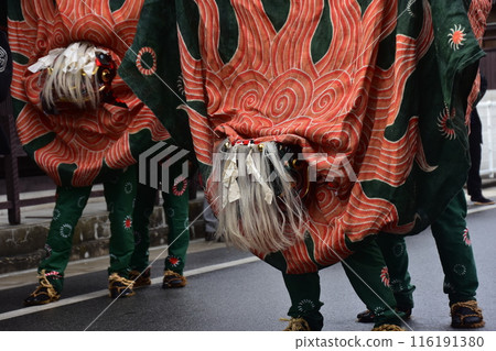 Takayama City, Gifu Prefecture, Japan: Traditional performing arts at the Takayama Spring Festival. Lion dancers parade through the streets in festival costumes, shaking the lion's face. Takayama City, Gifu Prefecture, Japan: Traditional performing arts at the Takayama Spring Festival. Lion dancers parade through the streets in festival costumes, shaking the lion's face. 116191380