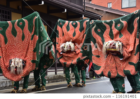 Takayama City, Gifu Prefecture, Japan: Traditional performing arts at the Takayama Spring Festival. Lion dancers parade through the streets in festival costumes, shaking the lion's face. Takayama City, Gifu Prefecture, Japan: Traditional performing arts at the Takayama Spring Festival. Lion dancers parade through the streets in festival costumes, shaking the lion's face. 116191401
