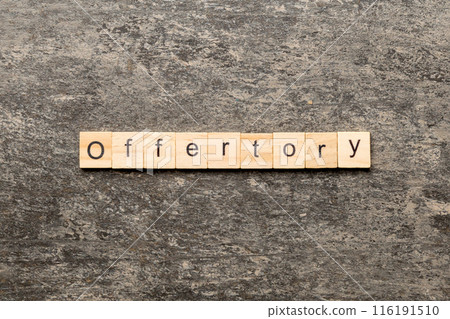 offertory word written on wood block. offertory text on table, concept offertory word written on wood block. offertory text on table, concept 116191510
