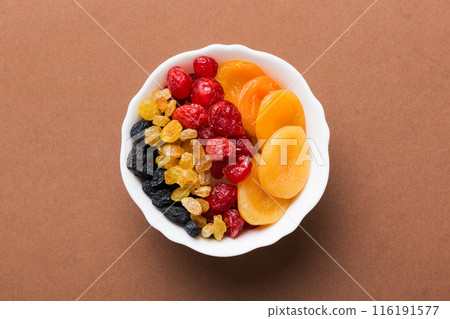 Bowl with different dried fruits on table background, top view. Healthy lifestyle with copy space 116191577