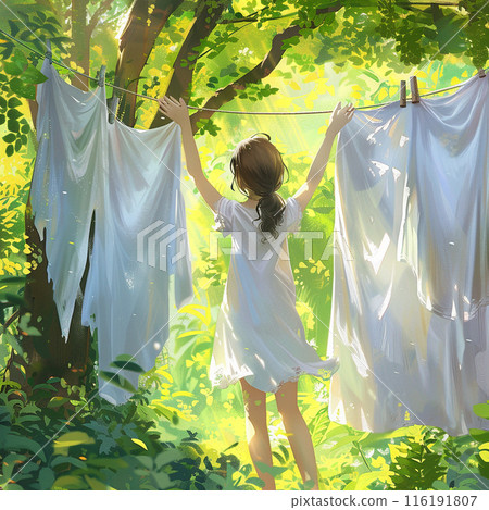 A girl hangs white laundry in nature, in the light of the sun 116191807