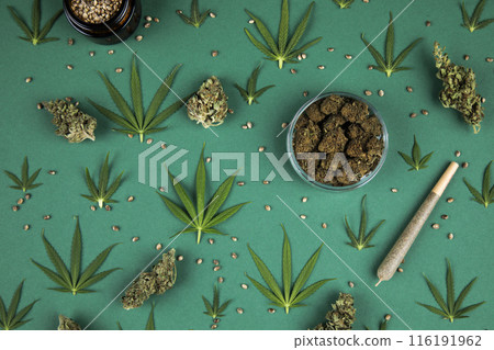 Flat lay, Top view of marijuana leaves and cannabis buds, cbd concept Flat lay, Top view of marijuana leaves and cannabis buds, cbd concept 116191962