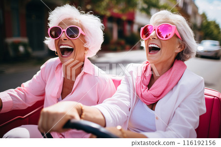 Company of elderly girlfriends of pensioners on a trip ride a convertible car and have fun Company of elderly girlfriends of pensioners on a trip ride a convertible car and have fun 116192156