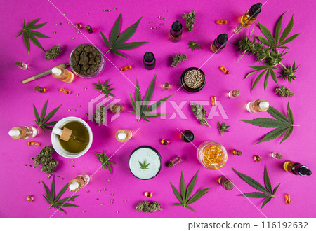 Cannabis leaf with oil bottle and hemp seeds on a pink background Cannabis leaf with oil bottle and hemp seeds on a pink background 116192632
