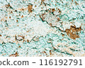 Close up of a weathered and peeling turquoise painted wall with exposed brown patches, texture, background. 116192791