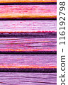 Close up of colorful wooden planks with a vibrant orange and purple hue, texture-background. 116192798