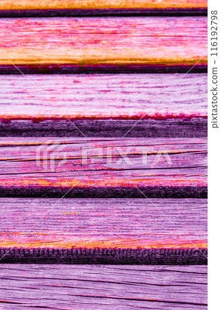 Close up of colorful wooden planks with a vibrant orange and purple hue, texture-background. Close up of colorful wooden planks with a vibrant orange and purple hue, texture-background. 116192798