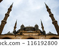 Low angle view of a mosque with four tall minarets against a cloudy sky, Mosque of Selim II, Edirne, Turkey. 116192800