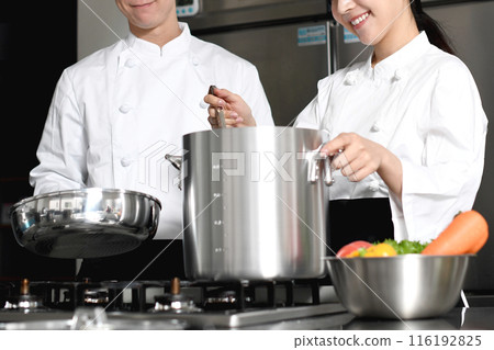 Young asian male and female chefs cooking in the kitchen 116192825