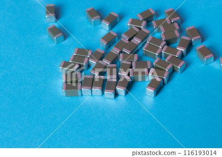 smd ceramic capacitors, on a blue table, electronic components 116193014