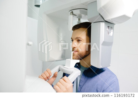 Panoramic image of teeth. A patient in a modern dental clinic takes a panoramic picture of the teeth. Prevention of dental diseases. Accurate diagnosis. 116193172