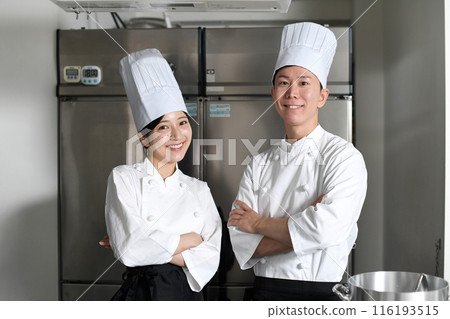 Asian male and female chefs with arms crossed in the kitchen 116193515