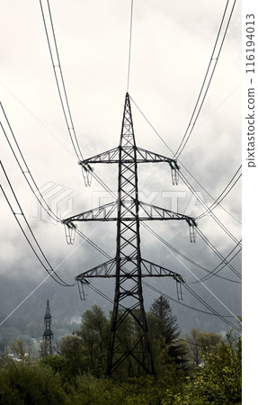 Industrial powerlines against cloudy sky 116194013