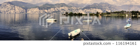 Alpine Panorama on Lake Garda in Italy with Few Moored Boats Before the Start of the Holiday Season 116194161