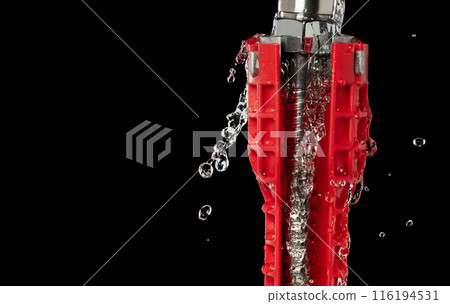 Water leak under sink on Nut Bolt stainless steel. Drain sink leak water from pipe plumbing in bathroom and repair by flume wrench tools as water splash drop. Black background isolated Water leak under sink on Nut Bolt stainless steel. Drain sink leak water from pipe plumbing in bathroom and repair by flume wrench tools as water splash drop. Black background isolated 116194531
