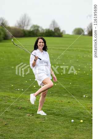 Beautiful woman showcasing her talent in golfing 116195690
