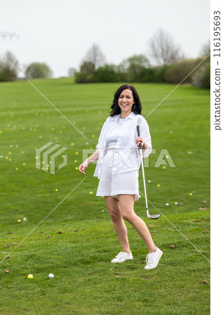 Sporty woman player enjoying the game on the green lawn Sporty woman player enjoying the game on the green lawn 116195693