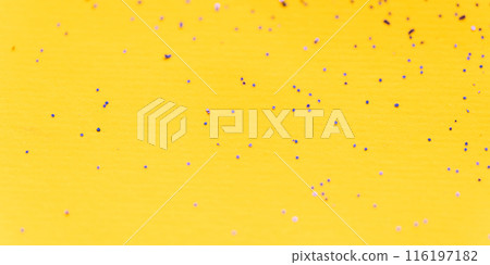 Background of shiny sparkles scattered on a yellow background Background of shiny sparkles scattered on a yellow background 116197182
