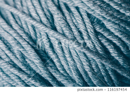 A close up of a blue yarn with a fuzzy texture 116197454