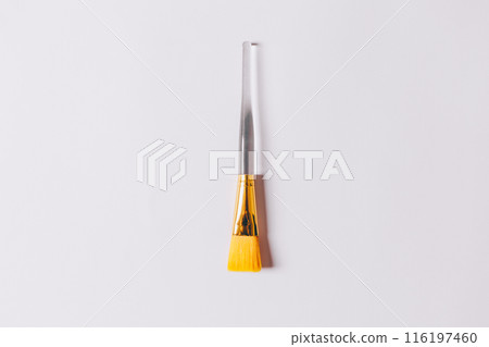 A yellow brush is on a white background A yellow brush is on a white background 116197460