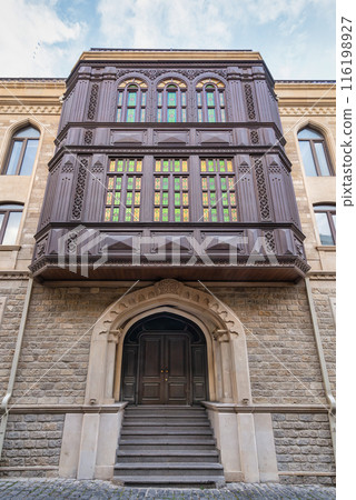 Traditional Azerbaijani building in Baku's Old Town features an ornate wooden balcony with stained glass windows Traditional Azerbaijani building in Baku's Old Town features an ornate wooden balcony with stained glass windows 116198927