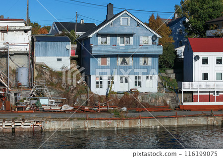 Coastal view of Kristiansund with wooden houses on a sunny day Coastal view of Kristiansund with wooden houses on a sunny day 116199075