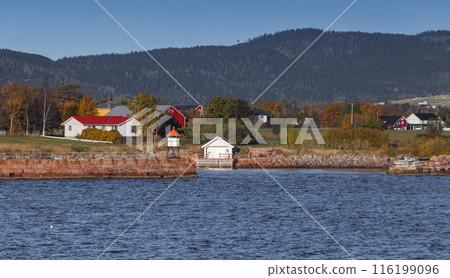 Norwegian landscape with a lighthouse tower, wooden houses Norwegian landscape with a lighthouse tower, wooden houses 116199096