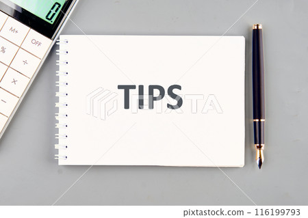The word TIPS in a notebook on a gray background The word TIPS in a notebook on a gray background 116199793