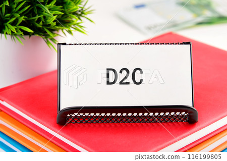 Business and D2C direct to consumer concept. Concept words D2C on a business card standing in a stand on a notepad 116199805