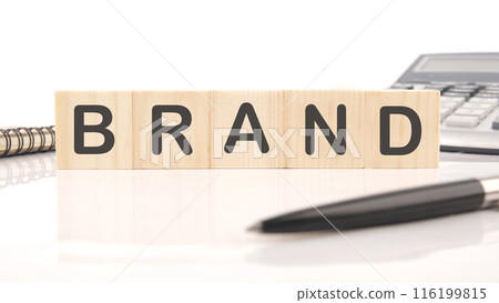 Customer retention concept. BRAND on wooden cubes in a composition with a calculator, a pen and a fragment of a notebook 116199815
