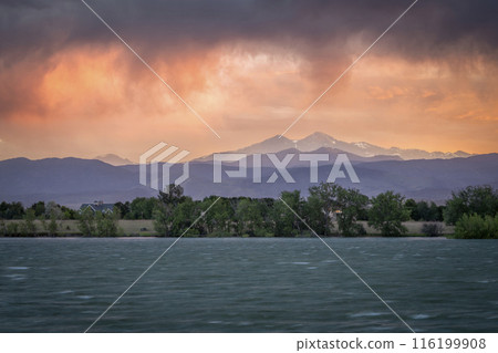 dramatic, stormy sunset with high wind over Longs Peak and Front Range of Rocky Mountains in northern Colorado 116199908