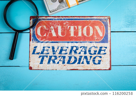 Leverage Trading. Caution sign with text on wooden texture table 116200258
