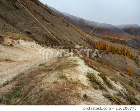 Empty dangerous narrow cliffside mountain road. Empty dangerous narrow cliffside mountain road. 116200773